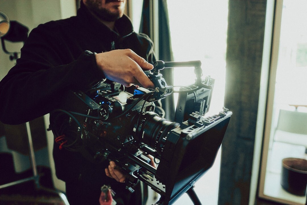 Camera operator filming in a television broadcast studio
